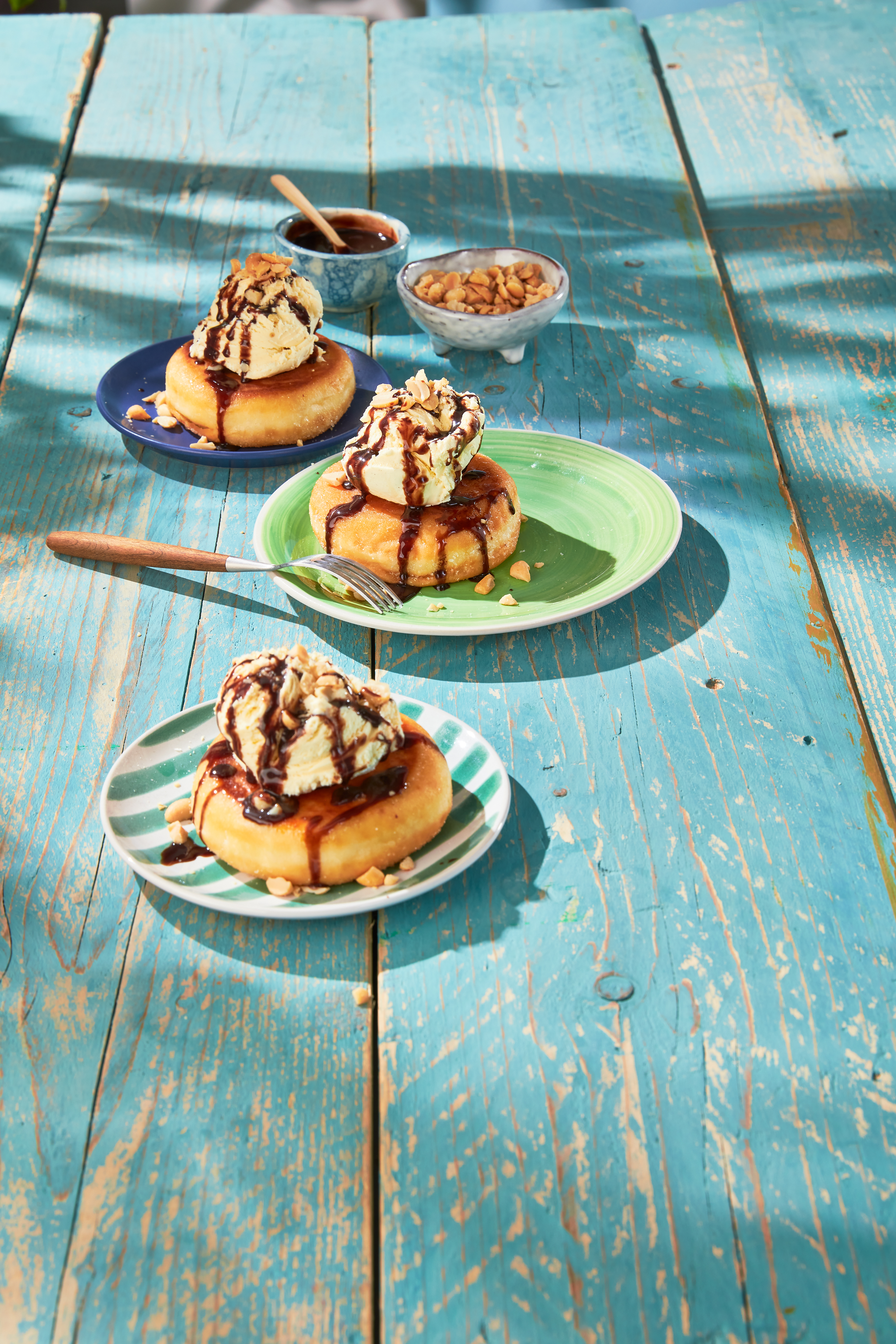 Gebakken donut met ijs, chocosaus en pinda's